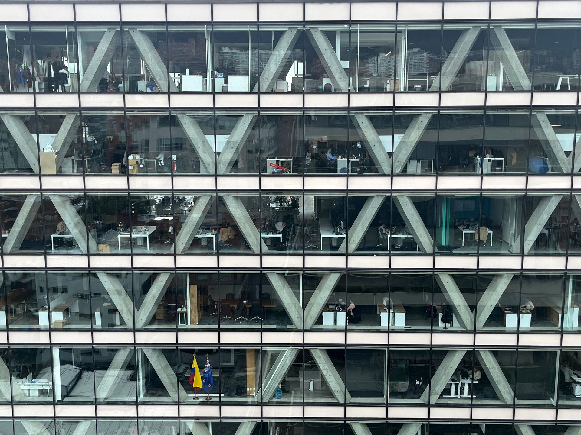 Office building facade with glass windows and geometric patterns in Bogota, Colombia.